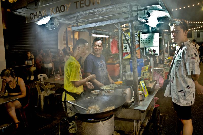 Take a closer look at the tables on the left, which are in front of a shop lot, and the smoke generated from his wok., Best food in Penang