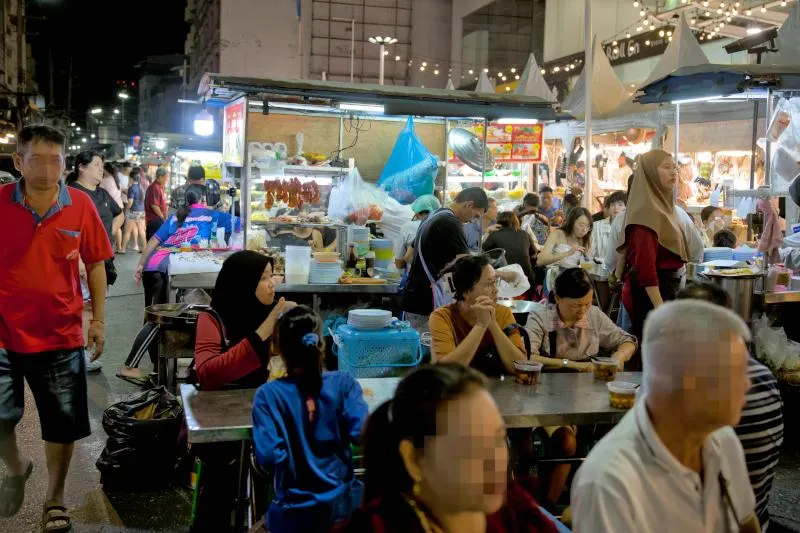 There are more stalls with tables and chairs for diners slightly away from the main area. - Lee Garden Night Market