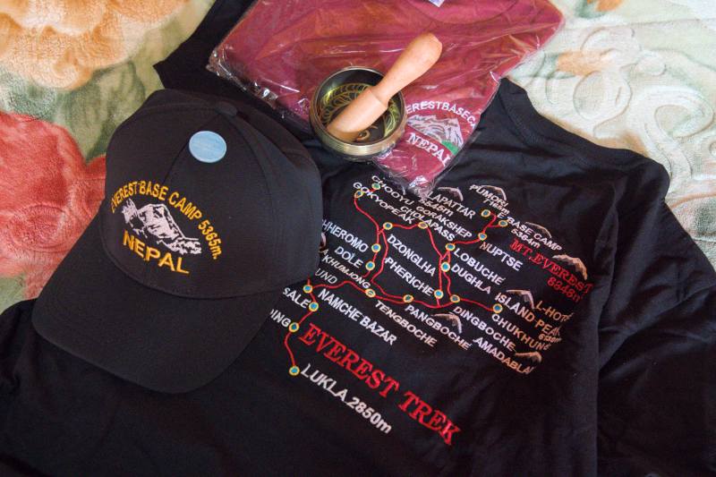 Everest Base Camp T-shirts, fridge magnets, and caps as mementos.